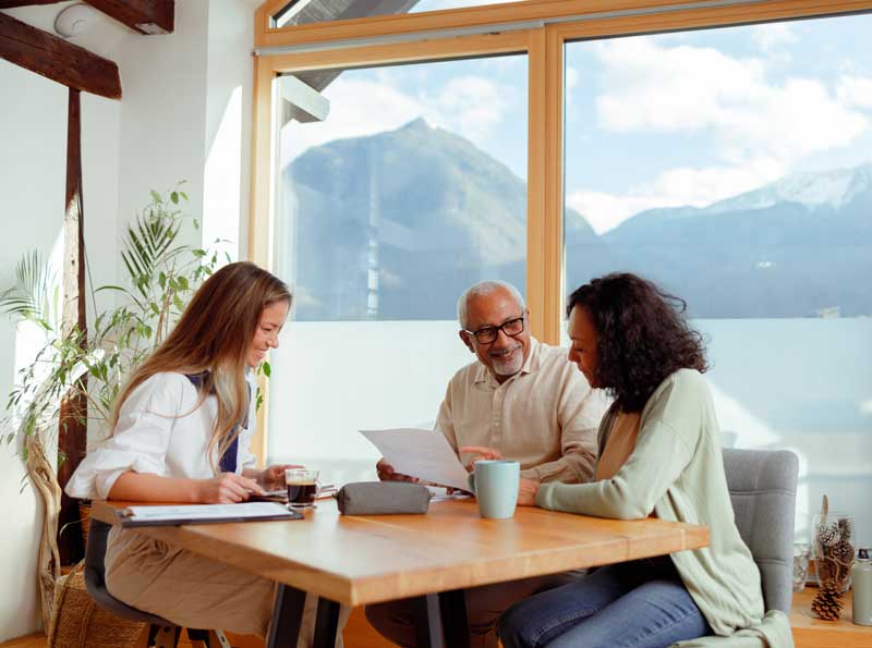 Three people sitting around a table